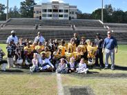Group picture with football players and cheerleaders
