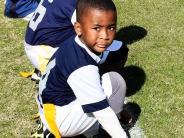 Youth Football Player Playing with grass