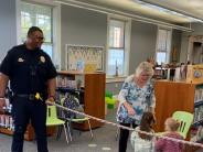 Ofc. Chelsey Hall with Keely and Kennedy doing Library Limbo