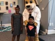 Dog In in a Medical Coat with Two Children